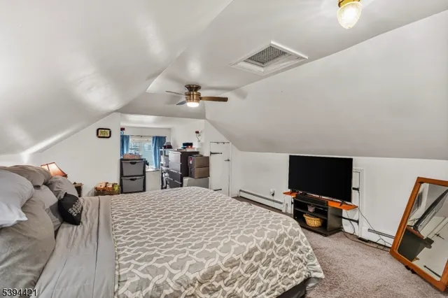 a bed room with a bed and a flat tv screen on a dresser