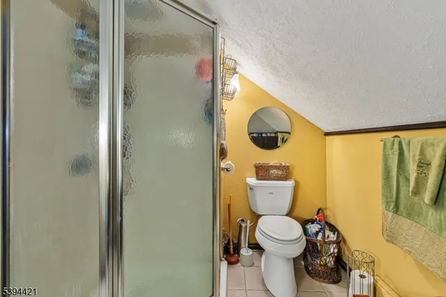 a bathroom with a toilet and a mirror