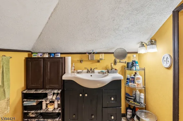 a bathroom with a sink vanity and a mirror