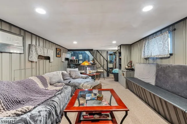 a bedroom with furniture and a large window