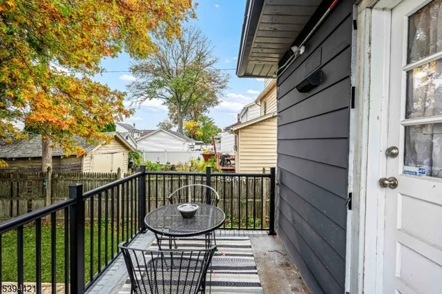 a view of balcony with wooden floor and fence
