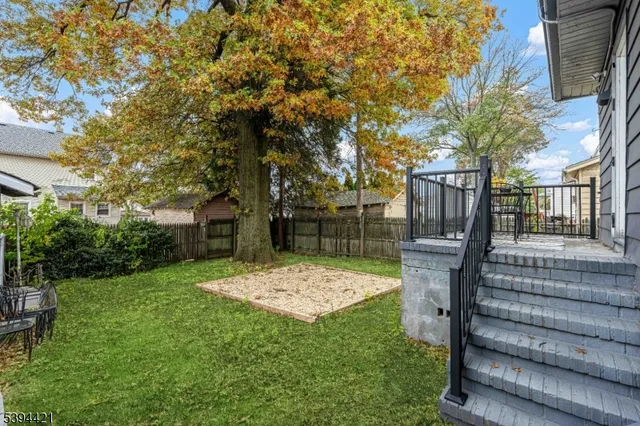a view of backyard with seating area and green space