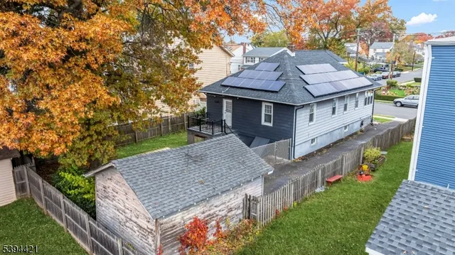 a view of house with backyard and trees
