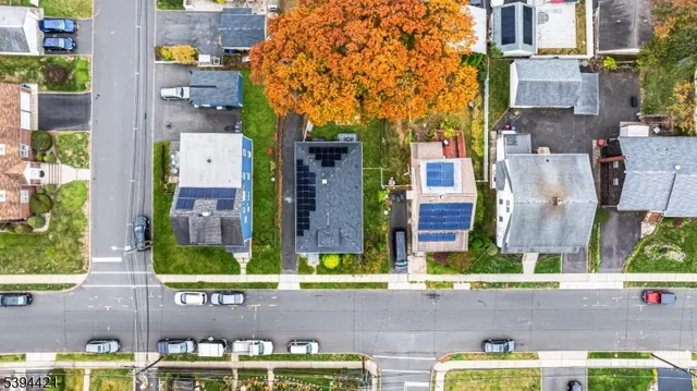 aerial view of multi story residential apartment building with yard