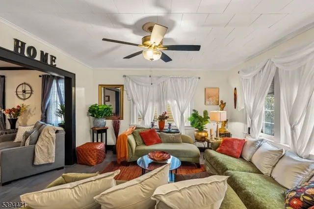 a living room with furniture ceiling fan and a rug