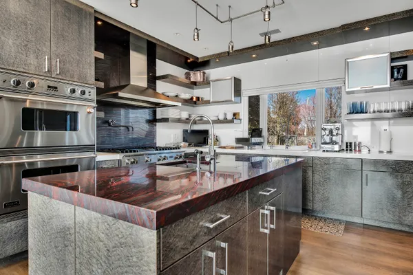 a kitchen with stainless steel appliances granite countertop a sink stove and refrigerator