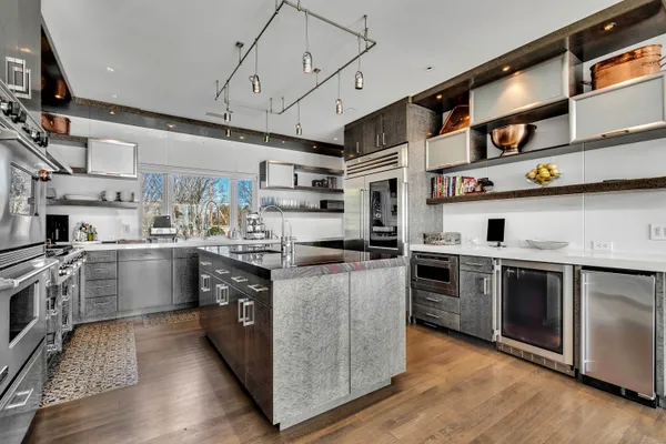 a kitchen with stainless steel appliances granite countertop a stove and a sink