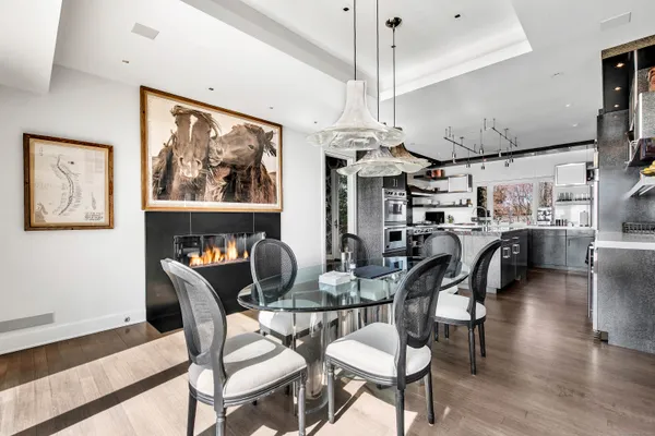 a dining room with furniture a chandelier and wooden floor