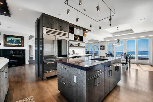 a kitchen with stainless steel appliances granite countertop a stove and cabinets
