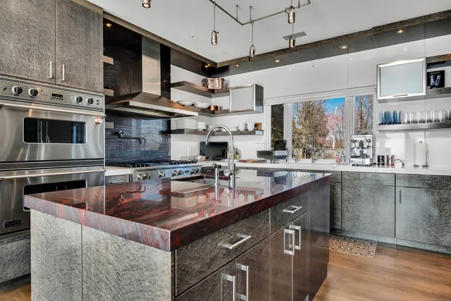 a kitchen with stainless steel appliances granite countertop a stove and a sink