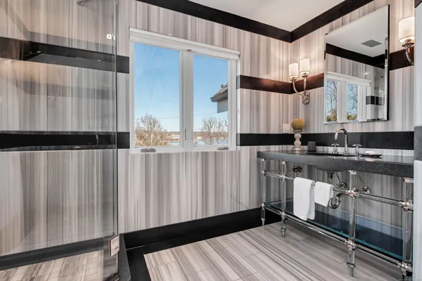 a bathroom with a sink a mirror and a shower