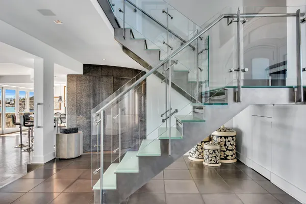 a large bed sitting in a bedroom next to a window