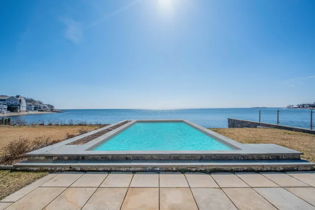 a living room with furniture potted plant and a large window