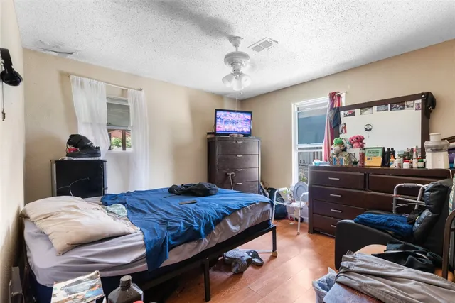 a bedroom with a bed and wooden floor