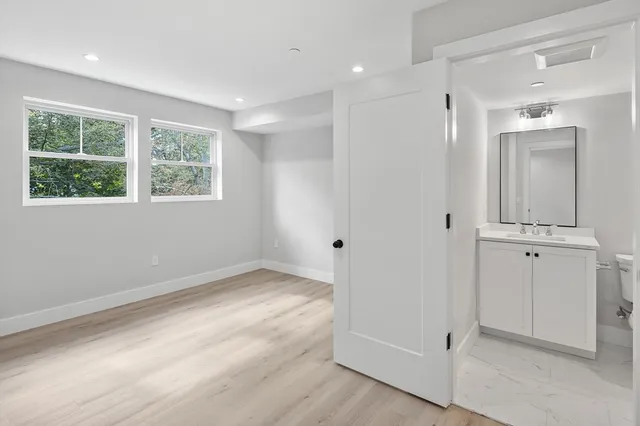 a view of a room with window and hardwood floor