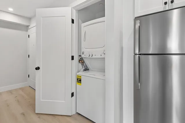 a white refrigerator freezer and a wooden floor