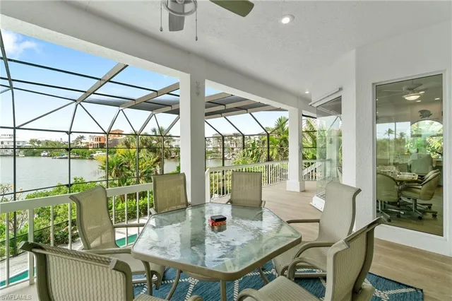 a balcony with furniture and a floor to ceiling window
