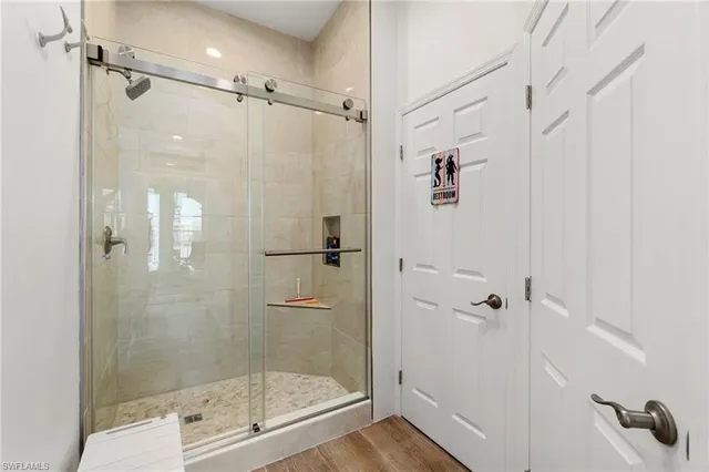 a bedroom with a bed and large windows