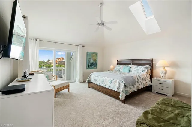 a bedroom with a large bed and a flat tv screen on dresser