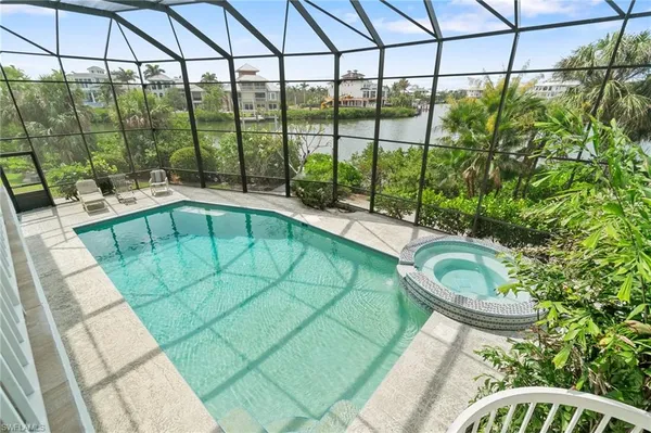 a living room with fireplace furniture and a large window
