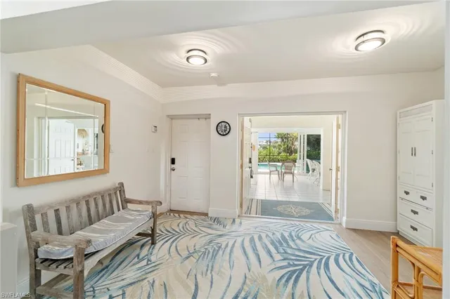 a living room with patio furniture and a large window