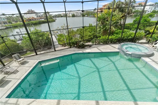 a view of a patio with a table and chairs under an umbrella