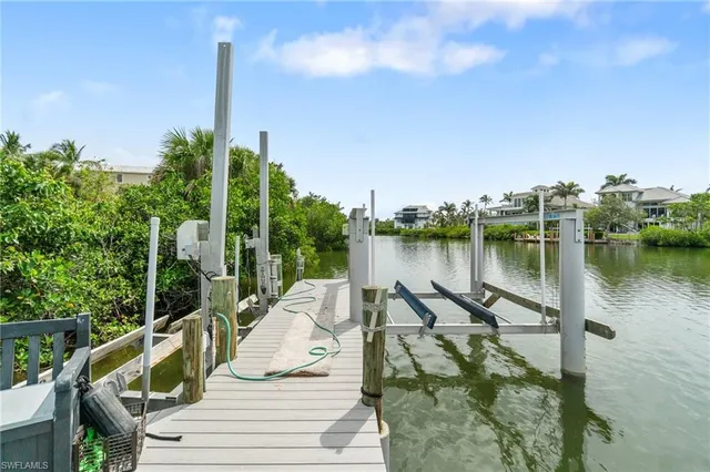 an aerial view of a houses with a lake