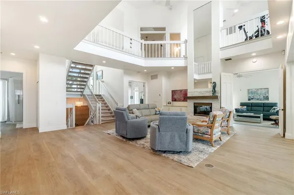 a living room with furniture and kitchen view