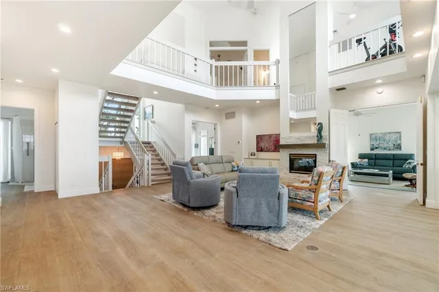 a living room with furniture and kitchen view