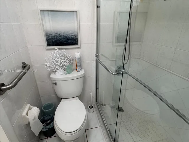 a white toilet sitting next to a bathroom sink