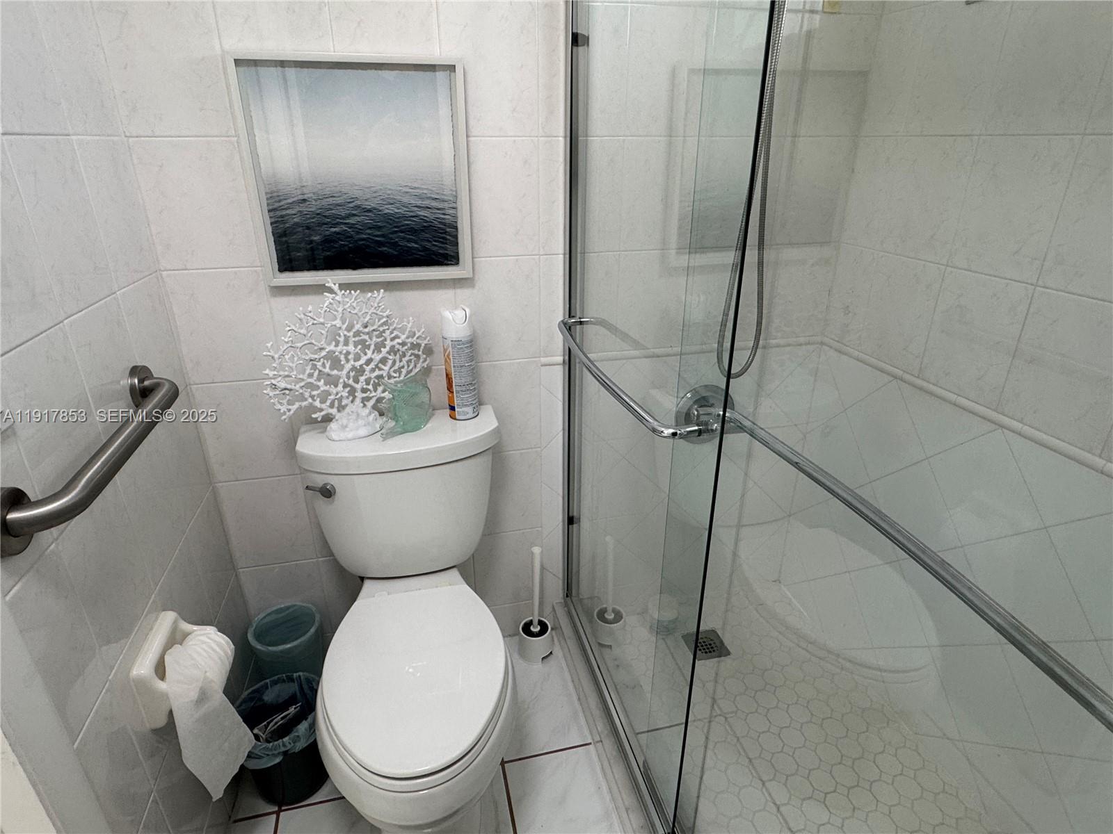 6050 Northwest 64th Avenue, Unit 306 Tamarac, FL 33319 - Photo 14 of 31 a bathroom with a toilet and a shower