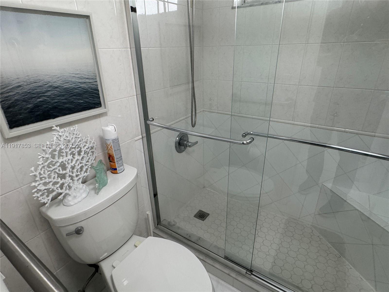 6050 Northwest 64th Avenue, Unit 306 Tamarac, FL 33319 - Photo 15 of 31 a white toilet sitting next to a bathroom sink