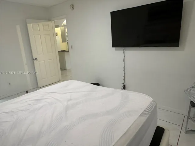 a bedroom with a bed and a chair