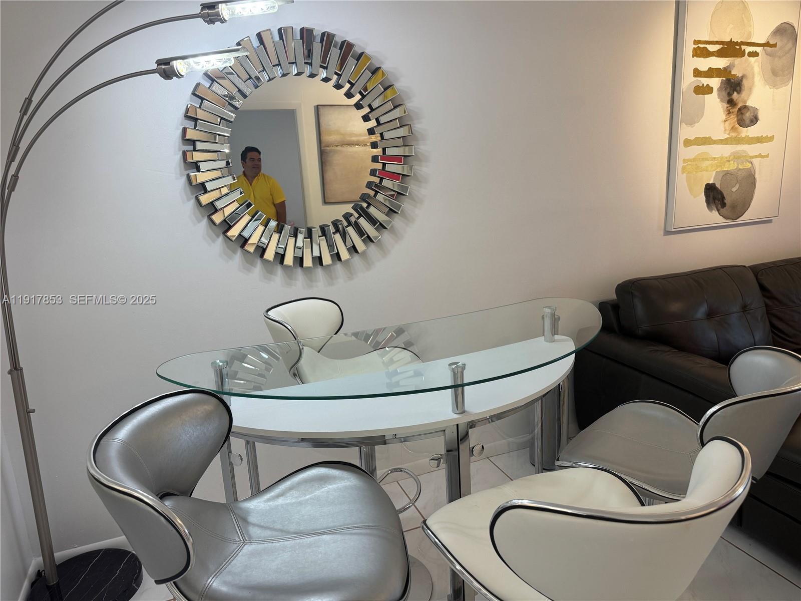 6050 Northwest 64th Avenue, Unit 306 Tamarac, FL 33319 - Photo 2 of 31 a living room with furniture a couch and a chandelier