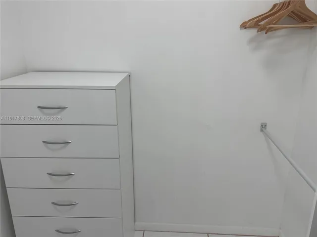 a living room with furniture and a mirror