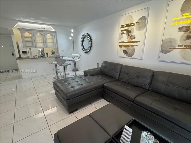 a living room with furniture and a mirror