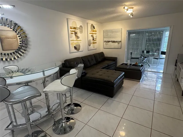 a living room with furniture and a mirror