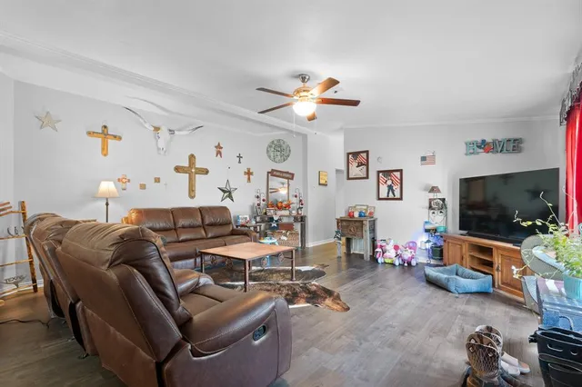 a living room with furniture and a flat screen tv