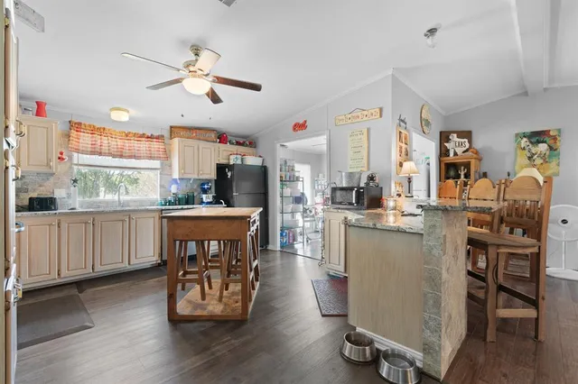 a kitchen with sink cabinets and wooden floor
