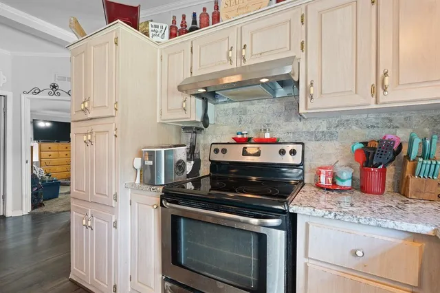 a kitchen with stainless steel appliances granite countertop a stove and cabinets