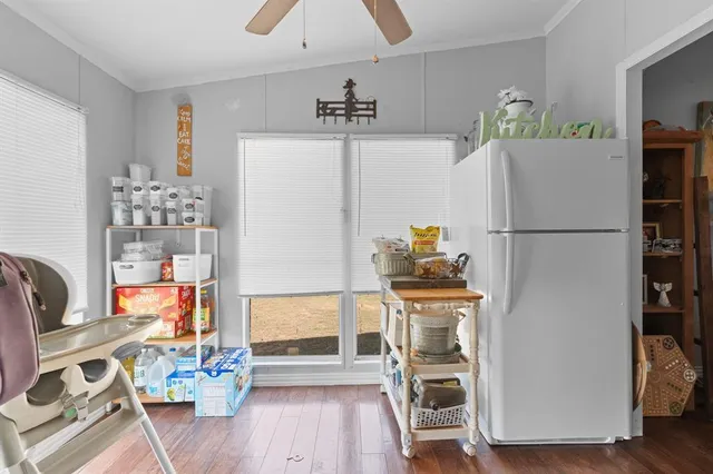 a kitchen with stainless steel appliances a refrigerator a stove a microwave and a dining table