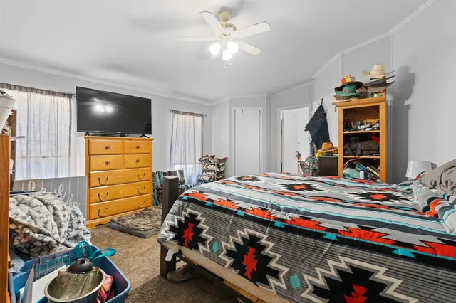 a bedroom with a bed and a tv