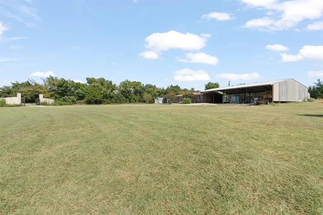 a view of patio with swimming pool and brick wall