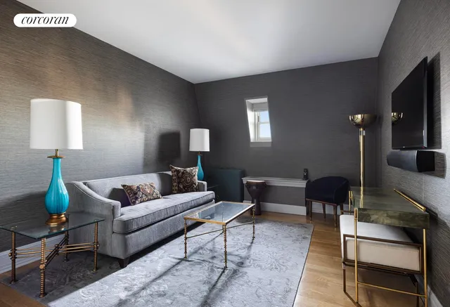 a living room with furniture and a lamp