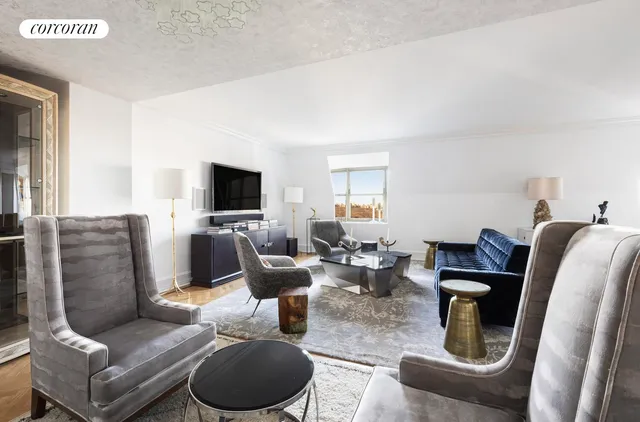 a living room with furniture a flat screen tv and a large window