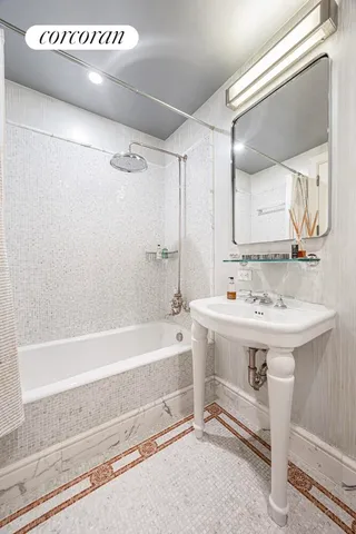 a bathroom with a sink a mirror and a bathtub