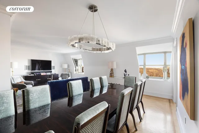 a view of a dining room with furniture a chandelier and wooden floor