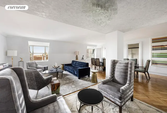 a living room with furniture wooden floor and a window
