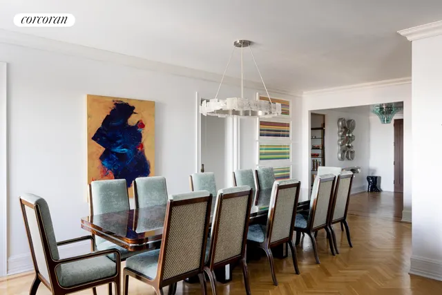 a view of a dining room with furniture a chandelier and wooden floor