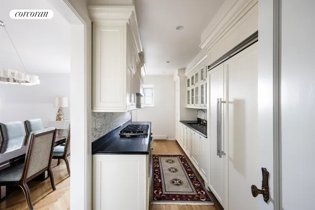 a kitchen with stainless steel appliances a stove a sink and a refrigerator